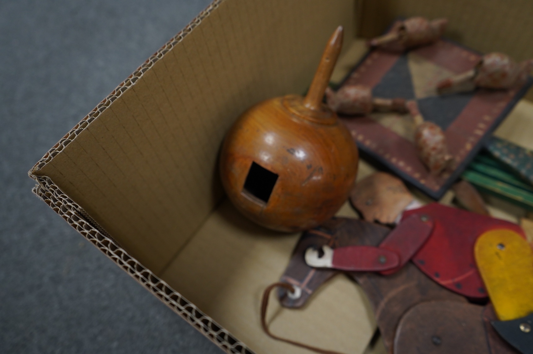 A collection of 19th century toys including; an early Jaques Ping Pong or Gossima set in an illustrated wooden case, a Crandall’s John Gilpin wooden horse with folded linen backed poster, ‘The Adventures of John Gilpin’